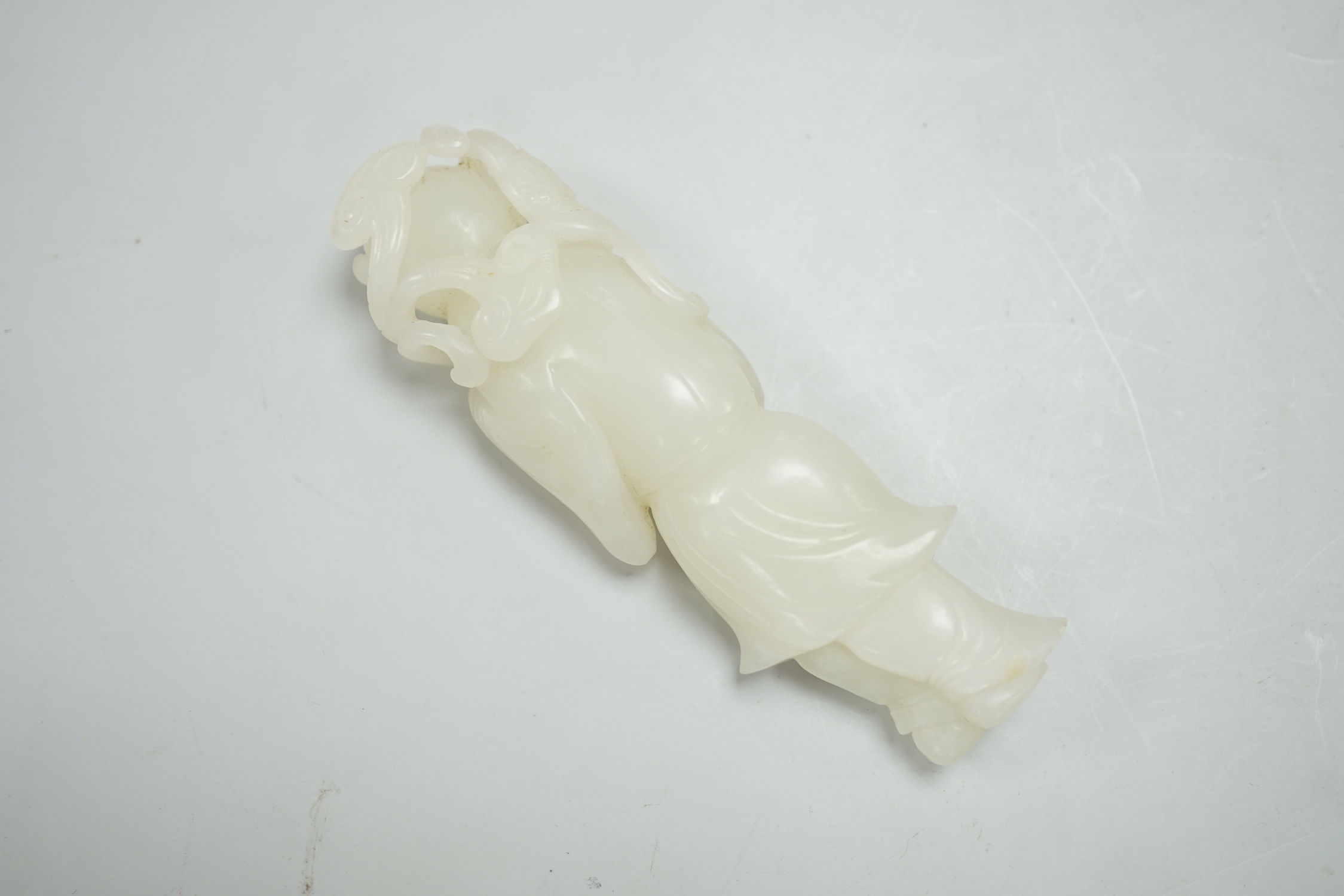 A Chinese white jade figure of a lady holding a sprig of fungus, 10cm high